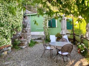 a table and chairs in front of a green house at Villa Pietrafiore in Monterosso al Mare