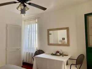 a dining room with a table and a ceiling fan at Villa Pietrafiore in Monterosso al Mare