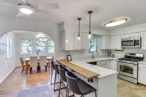 a kitchen with white cabinets and a table with chairs at 6 Mi to Dtwn Family-Friendly Home in Annapolis! in Annapolis