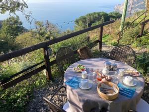 a table with food on it with a view of the ocean at Villa Pietrafiore in Monterosso al Mare