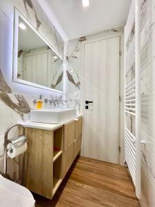 a bathroom with a sink and a mirror at BlueLine apartment 1 in Loutraki +29 photos