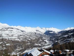 a view of a snowy mountain range with a town at Résidence Le Sextant - SEXTANT 405 MAE-0551 in La Plagne Tarentaise