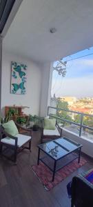 a living room with a table and chairs and a window at Dep #1 Basilio in Puerto Vallarta
