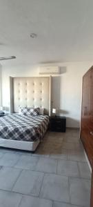 a bedroom with a large bed and a wooden cabinet at Dep #1 Basilio in Puerto Vallarta
