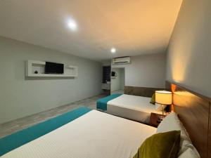 Postel nebo postele na pokoji v ubytování Hotel Awazul Bacalar