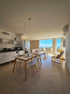 eine Küche und ein Esszimmer mit Tisch und Stühlen in der Unterkunft Médanos Patagonia in Las Grutas