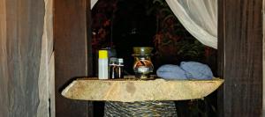 a shelf with a vase and blue balls on it at Hostería RIVER PARADISE in Río Negro