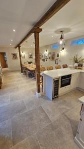 a kitchen and dining room with a table in the background at Linnels Coach House in Hexham