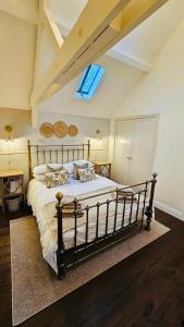 a bedroom with a large bed with a window at Linnels Coach House in Hexham