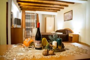 a table with a bottle of wine and a glass at Matsurev Han in Bansko