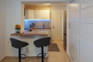 a kitchen with a counter and two stools at Central Messe Airport DUS Apartment with Terrace in Duisburg