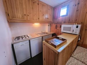 małą kuchnię z kuchenką i kuchenką mikrofalową w obiekcie Résidence Trolle-soldanelle - Appartement 4 personnes fonctionnel MAE-7811 w mieście Bonneval-sur-Arc +5 zdjęć