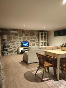 a living room with a couch and a table at Vale Das 7Lagoas in Geres