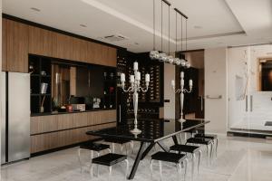 a dining room with a black table and chairs at Diwine Spa House Fruška Gora in Irig