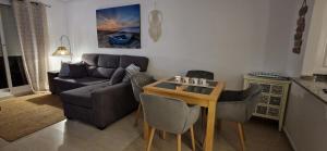 a living room with a couch and a table at Estrella in Mar de Cristal