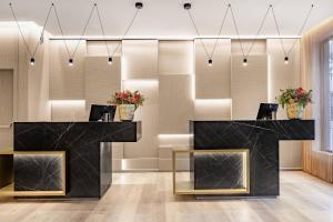 a lobby with a black counter with flowers at AC Hotel by Marriott Tenerife in Santa Cruz de Tenerife