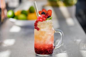 a mason jar filled with a drink with fruit on top at AC Hotel by Marriott Tenerife in Santa Cruz de Tenerife