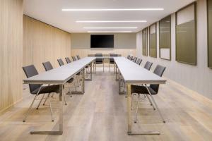 a conference room with a long table and chairs at AC Hotel by Marriott Tenerife in Santa Cruz de Tenerife