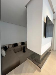 a living room with a couch and a flat screen tv at Villa Tagana in Marrakesh