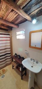 a bathroom with a sink and a mirror at La Casa de Amalia in Tumbaya