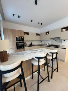 a kitchen with a large table and stools at Villa Tagana in Marrakesh