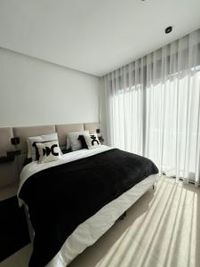 a bedroom with a large bed and a large window at Villa Tagana in Marrakesh