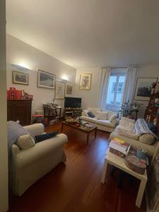 a living room with two couches and a tv at Camera privata in Santa Croce in Florence