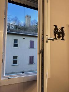 an open door with a view of a building at Torre Antica Montese appartamento 2 in Montese