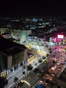 a city at night with cars on a busy street at Dragos Nest Center in Kamëz