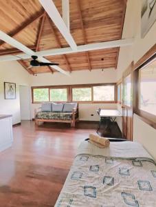 a large room with a bed and a couch at Villa Carpe Diem in Cocles