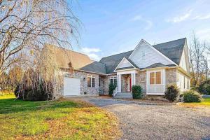 a large white house with a driveway at Stoney Creek Cottage Minutes to Wintergreen in Nellysford