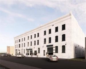 a white building with cars parked in front of it at Breakfast at Tiffanys Downtown Newport News in Hampton