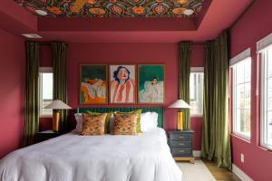 a bedroom with red walls and a large white bed at The Lyric - New Luxury Home, Rooftop with Firepit! in Nashville