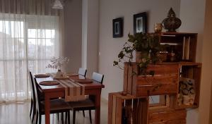 a dining room with a wooden table with chairs at Apartamento Acogedor con Mucha Luz in Brenes