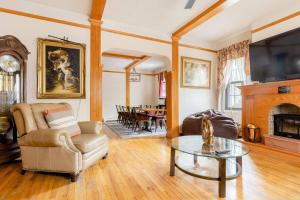 a living room with a couch and a table at Sweet Home - Zoller Stays in Long Island City
