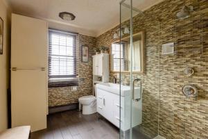 a bathroom with a toilet and a glass shower at Sweet Home - Zoller Stays in Long Island City