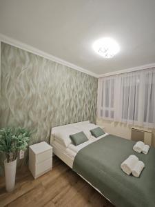 Postel nebo postele na pokoji v ubytování Central Greatforest Apartman