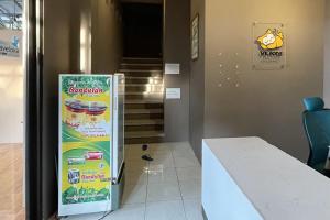 a refrigerator in a room with a table and stairs at VK Pods Pangandaran in Pangandaran +37 photos