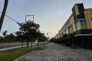 a cobblestone sidewalk next to a building and a street at VK Pods Pangandaran in Pangandaran