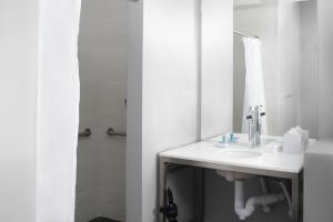 un baño con lavabo y espejo en Aloft El Paso Downtown, en El Paso 12 fotos más
