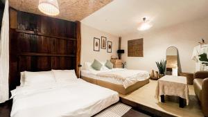 a bedroom with two beds and a chair at ซือรี ก๊ะฉิ - Suri Kachi ที่พักดอยช้าง in Ban Huai Khai +32 photos