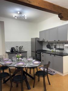 a dining room with a table and chairs in a kitchen at La casa di Canneto in Genova