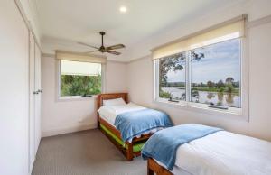 a bedroom with two beds and a window at Clarence River Retreat - Oceanstays - Farmstay & Jetty in Lawrence +55 photos
