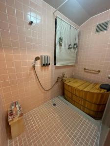 a bathroom with a wooden tub and a window at Satsuma vacation Bougainvillea cafe in Kagoshima +73 photos