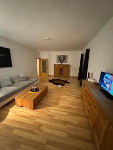 a living room with a couch and a coffee table at 2 Zimmer Whg in SN Mitte in Schwerin +4 photos