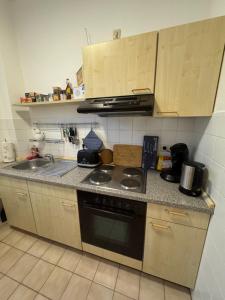 a kitchen with a sink and a stove top oven at 2 Zimmer Whg in SN Mitte in Schwerin