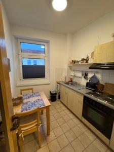 a kitchen with a table and a window in it at 2 Zimmer Whg in SN Mitte in Schwerin