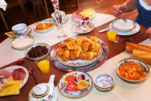 a table topped with plates of food and drinks at Hotel De La Poste in Langres