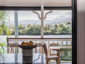 a table with a bowl of fruit on top of a window at Riviera Palms in Tumbulgum