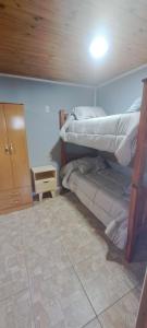 En eller flere senge i et værelse på Cabaña La Cruz del Sur